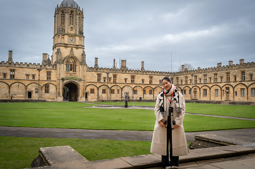 A  young woman visiting Oxford University  in UK.