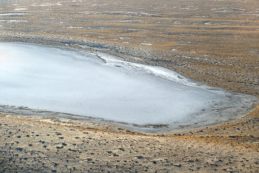 Aerial view of the vast Kati Thanda–Lake Eyre, an endorheic salt lake basin in the east-central part of the Far North region of South Australia. The lake contains the lowest natural point in Australia, at approximately 15 m below sea level.