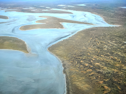 Aerial view of Kura-Kura-Pulanha islands and the Lake Eyre South, part of Kati Thanda–Lake Eyre, an endorheic salt lake basin in the east-central part of the Far North region of South Australia. The lake contains the lowest natural point in Australia, at approximately 15 m below sea level.