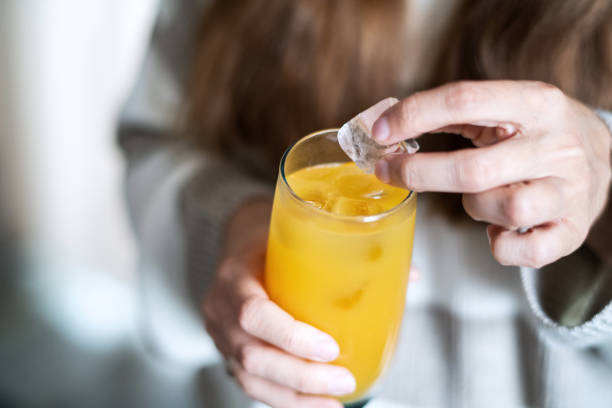 istock Woman removing ice from her juice because of dental problems 1931547627
