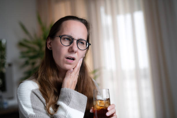 istock Woman with ice tea or soda drink suffering from tooth sensitivity 1931550613