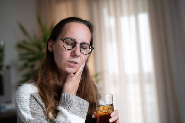 istock Woman with ice tea or soda drink suffering from tooth sensitivity 1931550739