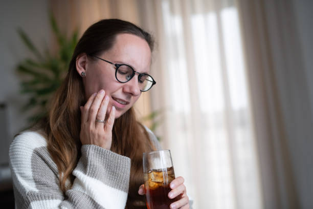istock Woman with ice tea or soda drink suffering from tooth sensitivity 1931551273