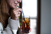 Woman putting metal straw in her drink