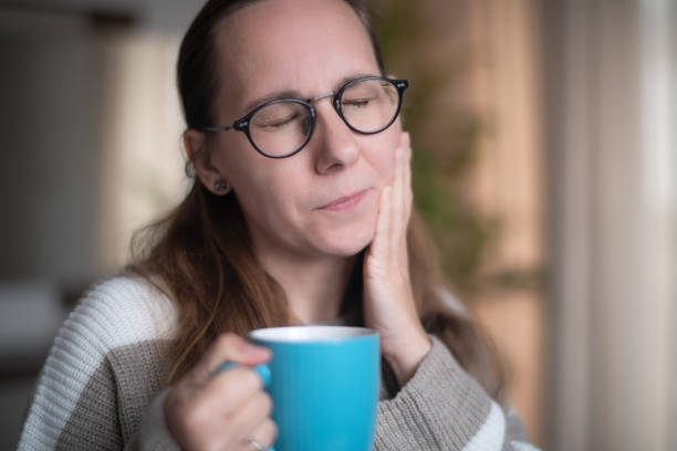 istock Woman with a cup of  hot tea suffering from tooth sensitivity 1931551812