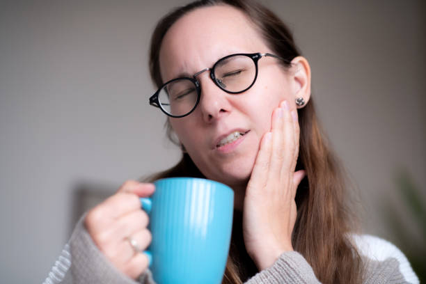 istock Woman with a cup of  hot tea suffering from tooth sensitivity 1931552343