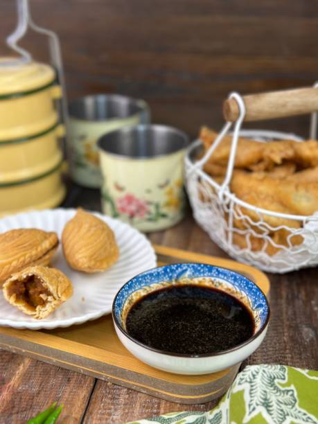 istock Curry Puffs Epok-Epok or Karipap Pusing - Deep Fried Malaysian, Singaporean, and Thai snack filled with curried meat and or vegetables. 1931552347