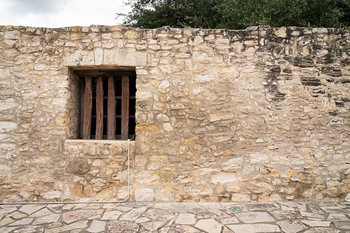 Stone wall with a wooden planks at the Alamo, Texas, USA