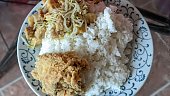 Mukbang with a plate of jumbo portions of rice with side dishes of Kentucky fried chicken and cooked tofu bean sprouts