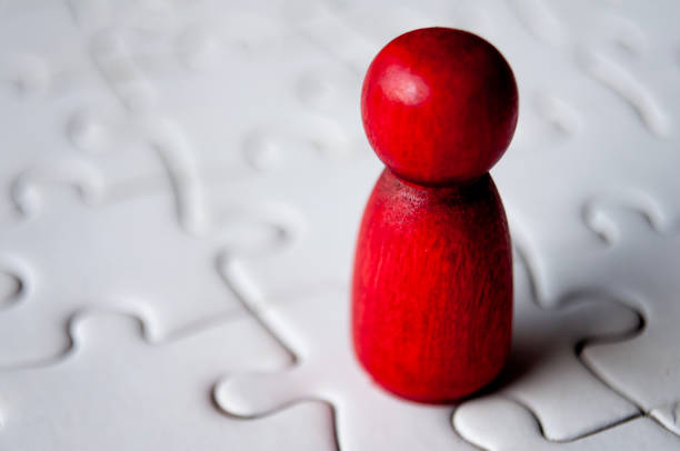 istock A single red wooden doll on jigsaw puzzle 1931664518