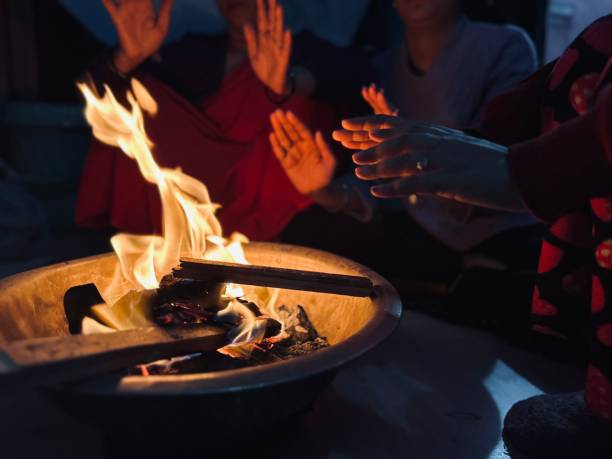 istock People warming hands while sitting around a bonfire in winter at home. 1931732560