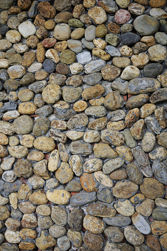 Background of home surrounding wall decorated by pebble rocks