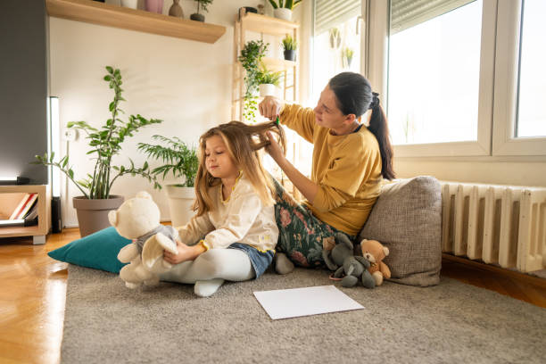 istock Mother doing head lice cleaning on daughter at home 1931782738