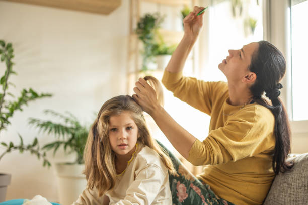 istock Mother doing head lice cleaning on daughter at home 1931794651