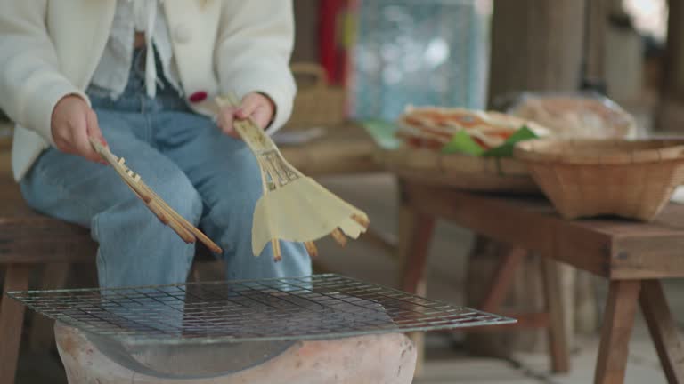 An Asian woman having fun making rice pong, a traditional northeastern food that has existed since ancient times, Khao Pong