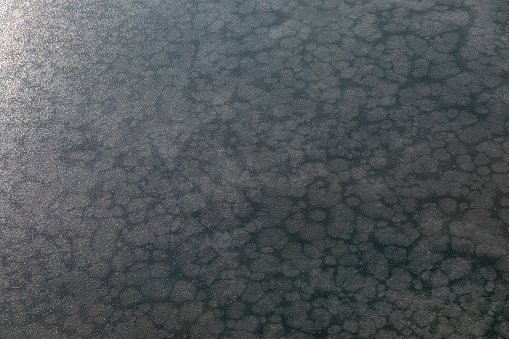 Texture of water frozen into ice during winter, resembling crystals
