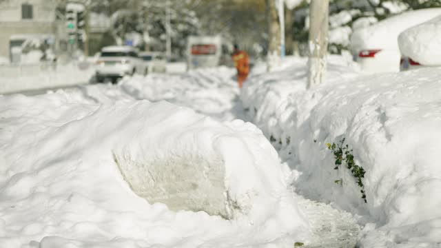 Sanitation workers are clearing snow in heavy winter snowfall