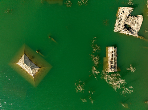 Aerial view of sunken village by dam waters. Taken via drone. Isparta, Türkiye.