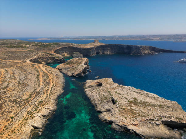 Experience serenity with an aerial view of Malta's Blue Lagoon, where crystal-clear waters and natural beauty create a mesmerising scene.