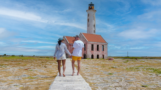 The Lighthouse of the small Island called Klein Curacao or Small Curacao. Couple of men and women visiting the lighthouse of Klein Curacao Island in the Caribbean during vacation
