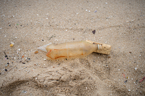 Discarded plastic water bottle washed on the beach