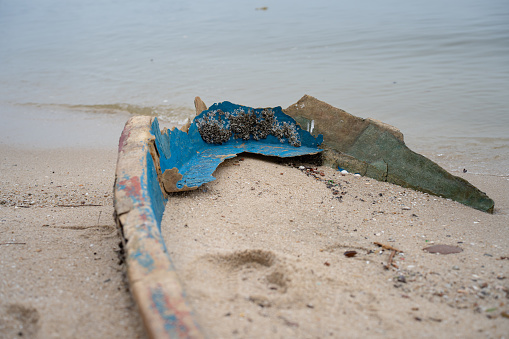Discarded plastic fibre abandon boat washed on the beach