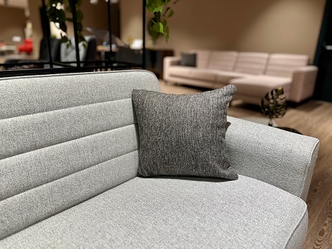 Stock photo showing close-up view of mustard yellow sofa with scatter cushions.