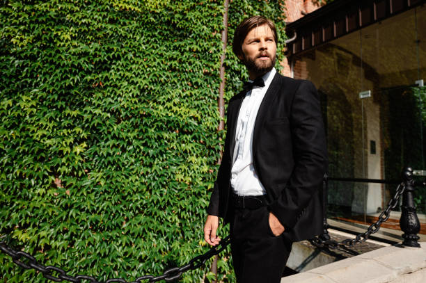 istock Handsome groom in stylish suit posing outdoors 1931915746