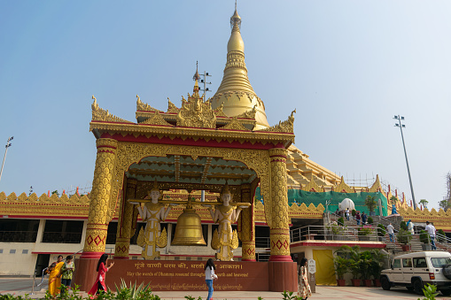 Mumbai, India - 20 November 2023, Picture of Buddhist temple with gong at Pagoda Vipassana Centre. Statues, Gautam Buddha, People, religion, peace, wish, desire, fulfilment, satisfaction, concentrate