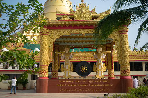 Mumbai, India - 20 November 2023, Gong and statues at Pagoda Vipassana Centre. Buddhism, Hinduism, bell, Dalai lama, peace, meditation, statue, religion, tourism, gorai, pilgrimage, monk, tourist love