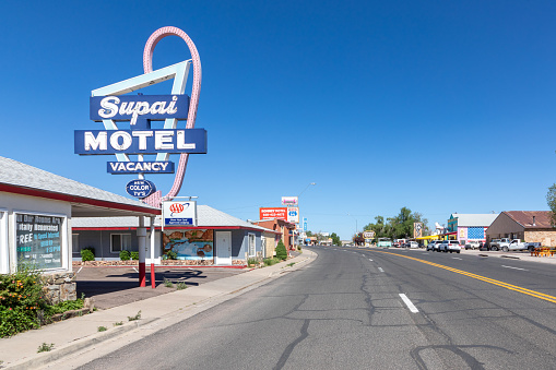 Seligman, USA - May 25, 2022: Motel and Route 66 sign Supai on Historic Route 66. Built in 1904. The neon light lost color but is still in use.