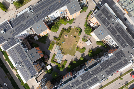 Aerial top down view of apartment buildings with solar panels on the roof tops in a residential district outside Stockholm.