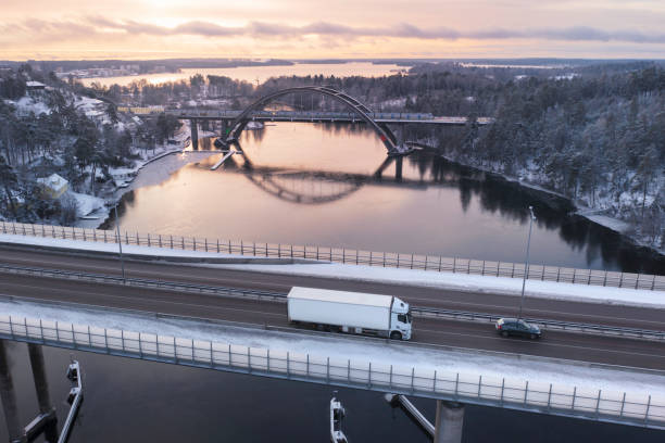 istock Truck on a highway bridge in winter sunlight 1931942682