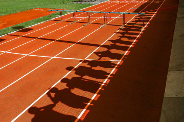 Blue and yellow hurdles at stadium running track for training close up