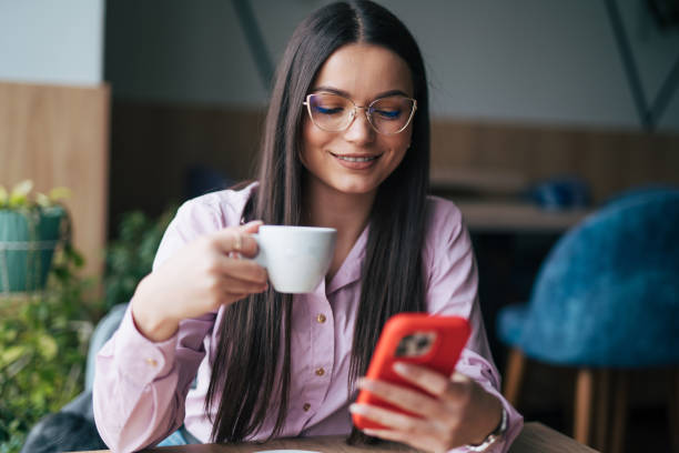 istock Beautiful young woman texting on smartphone 1931976581