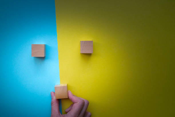 istock person with blank blocks on blue and yellow background 1931988097