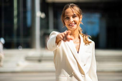 Young businesswoman pointing the finger to the camera, recruitment concept
