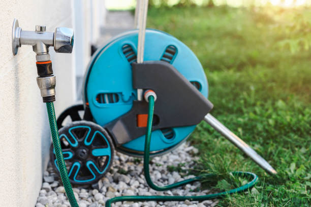 istock Garden Hose Reel with Water Tap Outside 1931997575