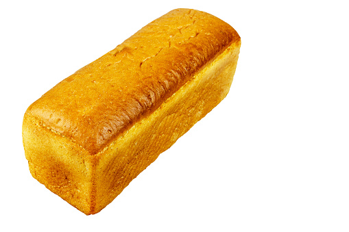 A large loaf of white bread isolated on a white background, view from the corner