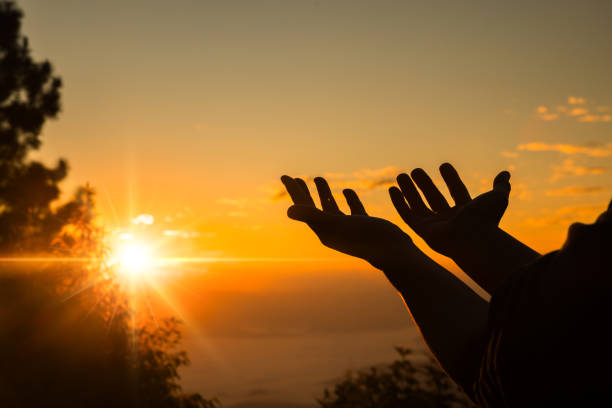 istock Person hands open palm up worship. Eucharist therapy bless god helping repent catholic easter lent mind pray. Fighting for god. Silhouette of woman worship in morning. Christian religion concept. 1932001482