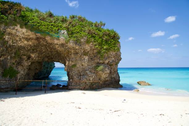 istock Picturesque beach with rock arch at Sunayama beach in Miyakojima. 1932017607