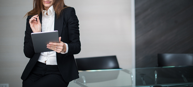 Business woman using a tablet in her modern office