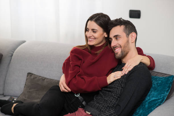 Couple watching television together