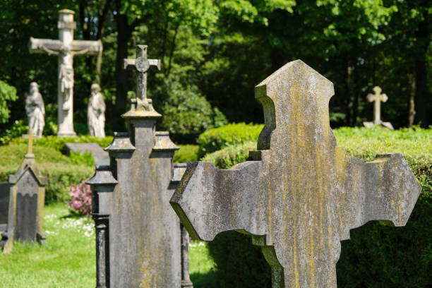 istock Catholic cemetery with old tombstones and crucifixion statue 1932045538