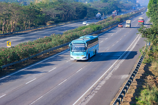Pune, India - January 14 2024: An eco friendly electric bus of the Maharashtra State Roadways, MSRTC heading towards Pune on the Mumbai to Pune Expressway near Pune India.