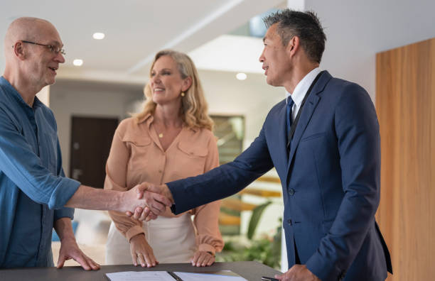 istock Male Estate Agent Shaking Hands With  Man 1932055017