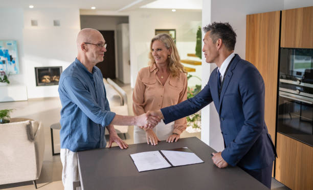 istock Male Estate Agent Shaking Hands With  Man 1932055034