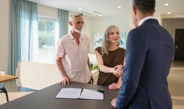 istock Male Estate Agent Shaking Hands With  Man 1932055036