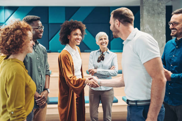 istock Businesswoman congratulating a colleague 1932080737