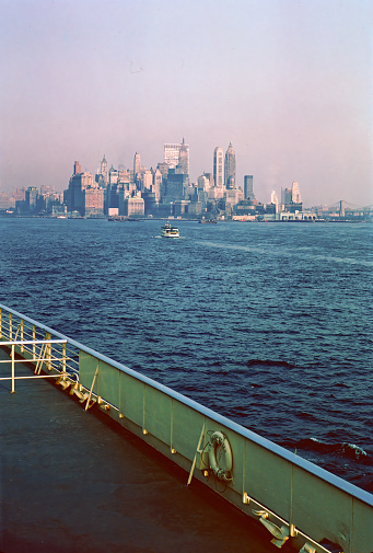 The skyline of New York City as seen from a ship in the state of New York in the United States of America in 1964